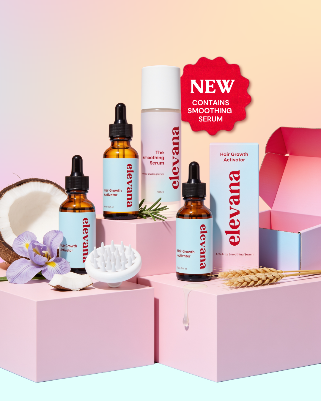 A haircare gift set from elevana featuring hair growth and smoothing products arranged on pink display boxes. The set includes two amber dropper bottles, a white serum bottle, a white activator box, an open pink and blue box, a purple flower, a coconut half, a white scalp massager, and wheat stalks, with a red 'NEW' badge.